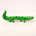 Green lizard-shaped dog chew toy with squeaker, measuring 24 cm long for aggressive chewers