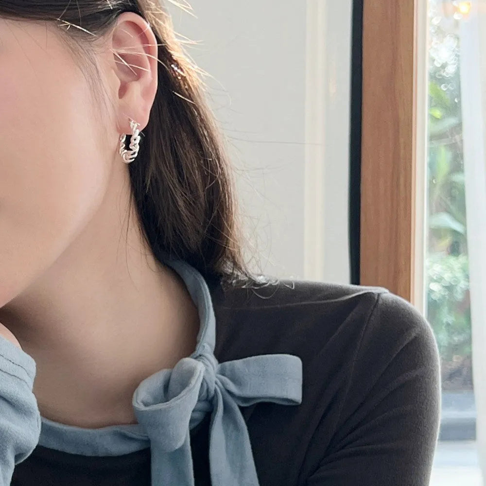 Argent Pur 925 silver ear studs with electroplated silver finish on a neutral background