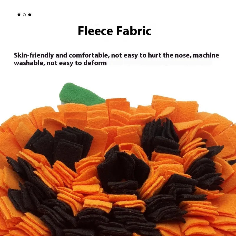Orange pumpkin-shaped woollen pet training mat on floor with dog treats