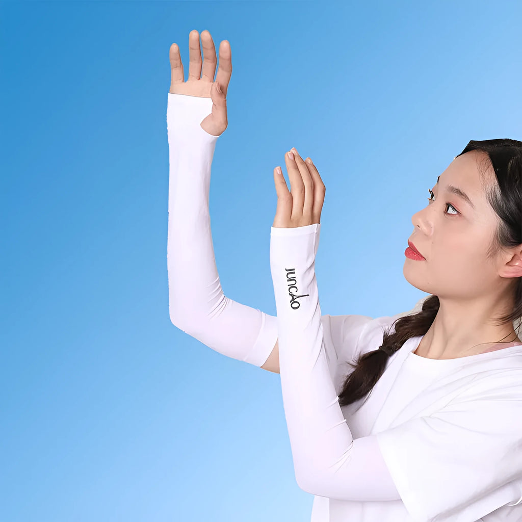 A person wearing a light grey nylon sun protection oversleeve on their arm with open fingers, suitable for driving.