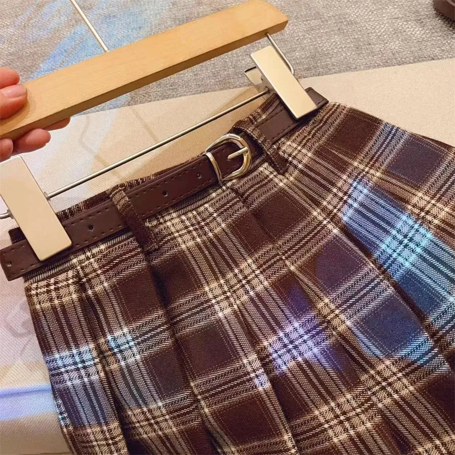 Girls' cotton plaid pleated skirt in A-line style showing pleat detail and plaid pattern