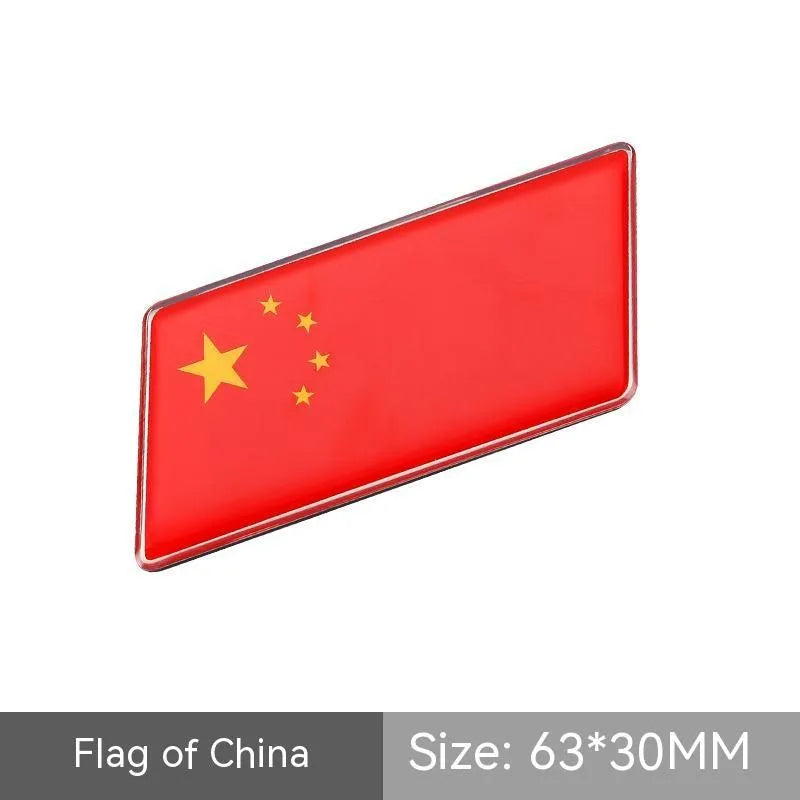 Aluminium national flag car sticker in a parallelogram shape measuring 6.3 by 3 centimetres.