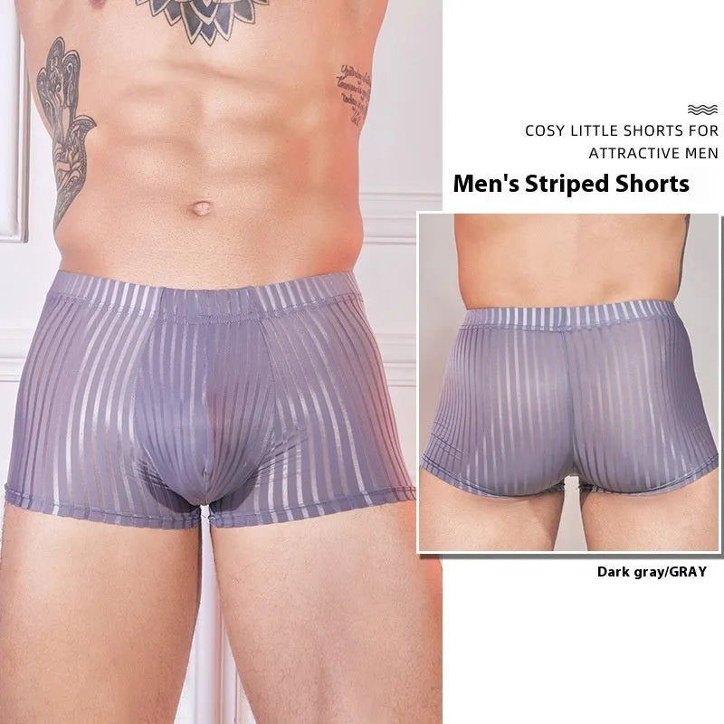 Men's black and white striped low-rise nylon briefs on a flat surface