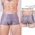 Men's black and white striped low-rise nylon briefs on a flat surface
