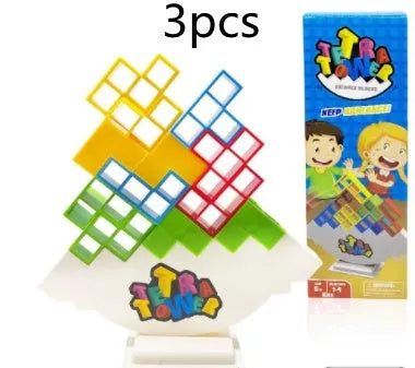 Plastic balance stacking game with 16 coloured blocks, chassis, and base on a table.