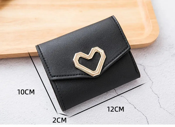Ladies tri-fold PU leather wallet with magnetic buckle, card slots, ID space, coin pocket, and heart decoration
