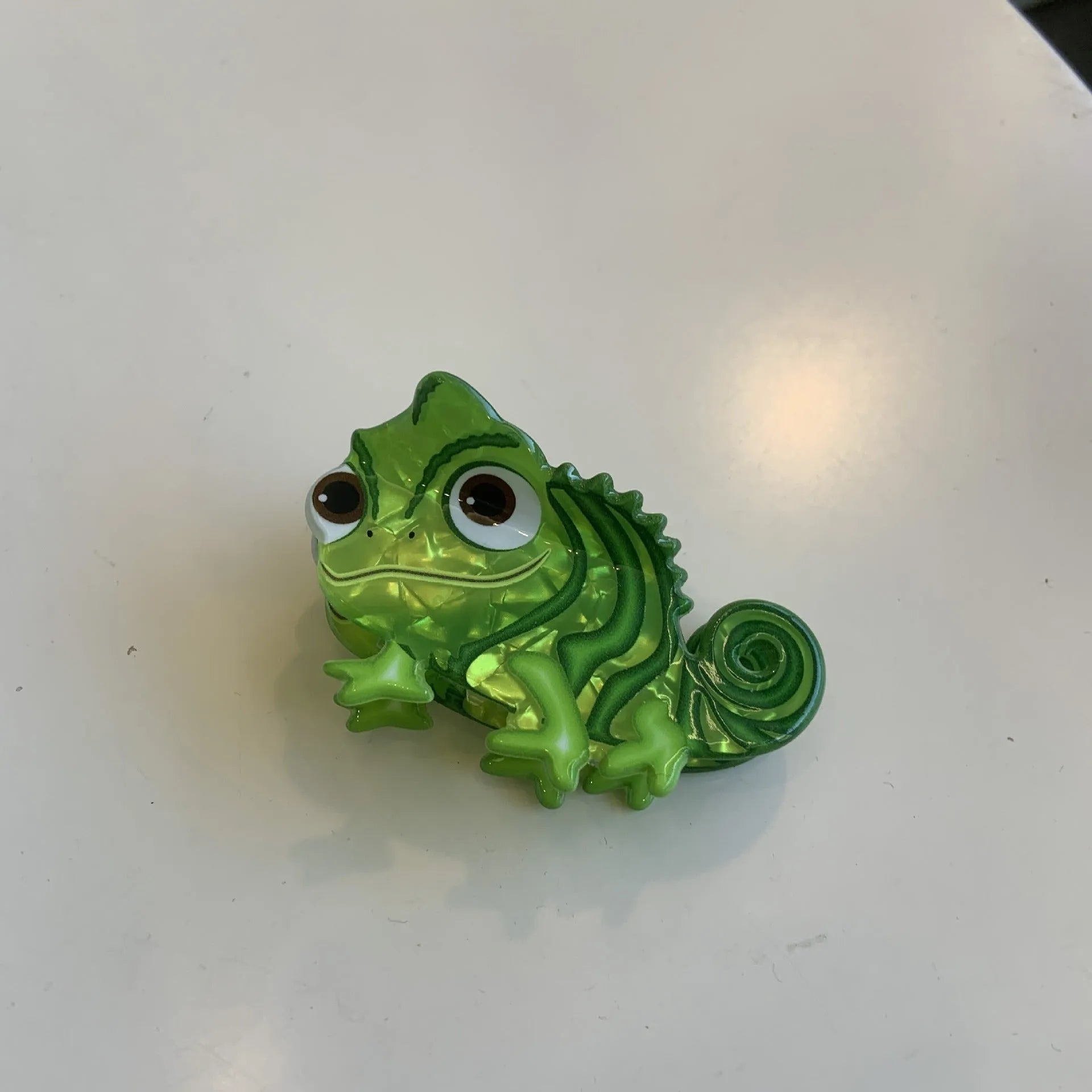 Colourful dinosaur-themed acrylic jaw hair clip showing multiple design options