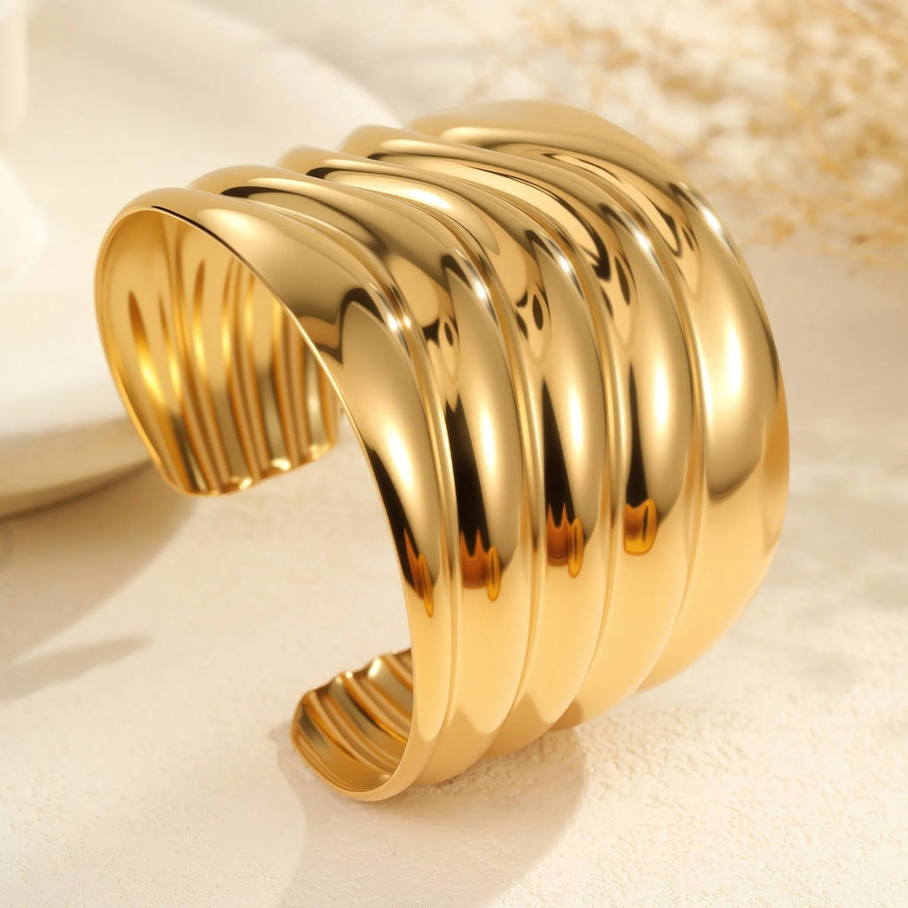 Women's fashion bracelet with exaggerated wide design and geometric wave pattern in gold plating