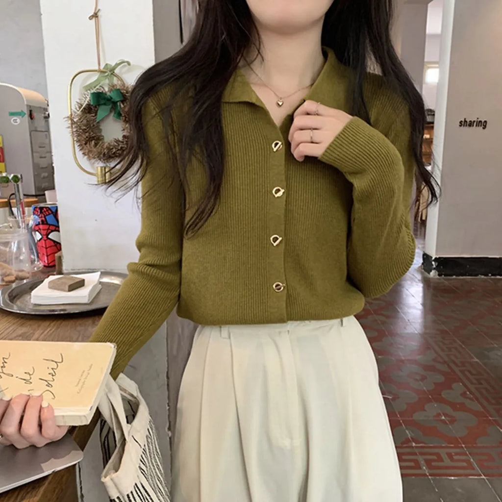 Long-sleeved beige viscose knitted cardigan top shown loose fit on a hanger