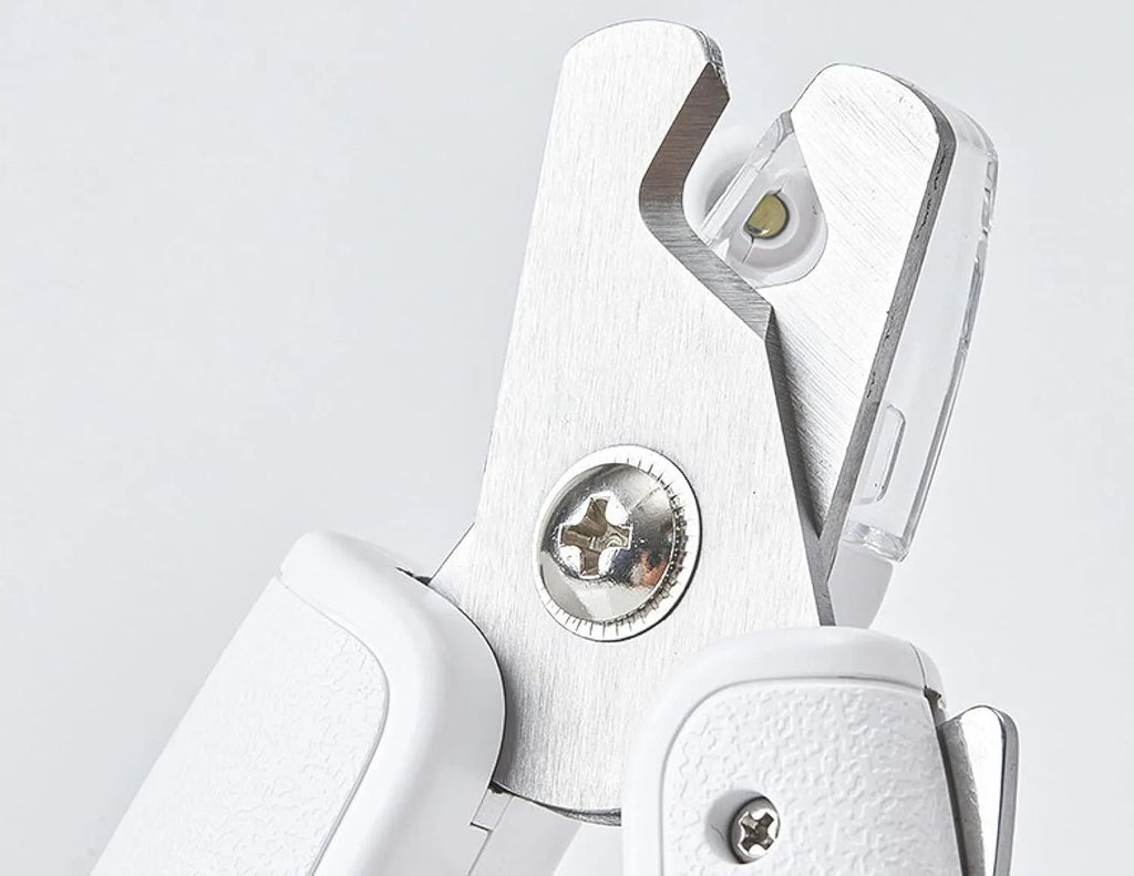White LED pet nail clipper with transparent anti-splash guard and nail file.