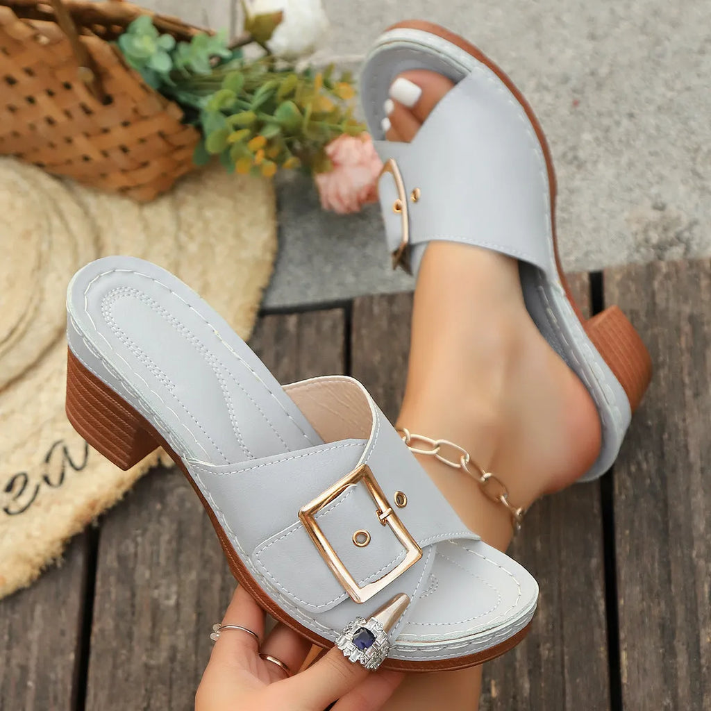 Women's retro style slippers with chunky heel and metal buckle detail in light blue colour