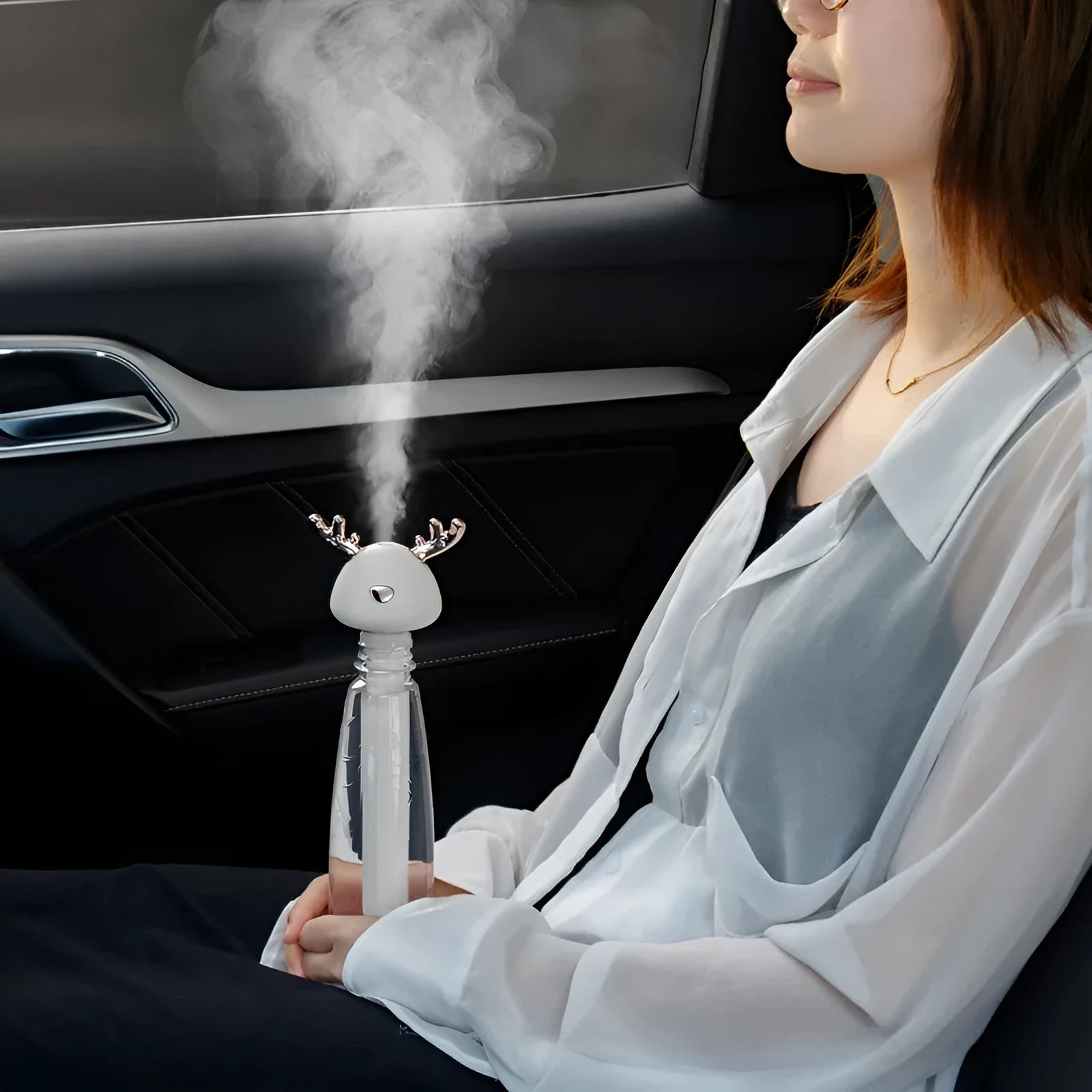 Mini USB portable car humidifier with creative little antler design in beige, showing water tank filler and USB cable