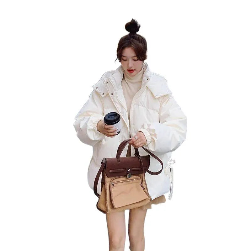 Women's milky white sleeveless insulated jacket with princess sleeves on a hanger