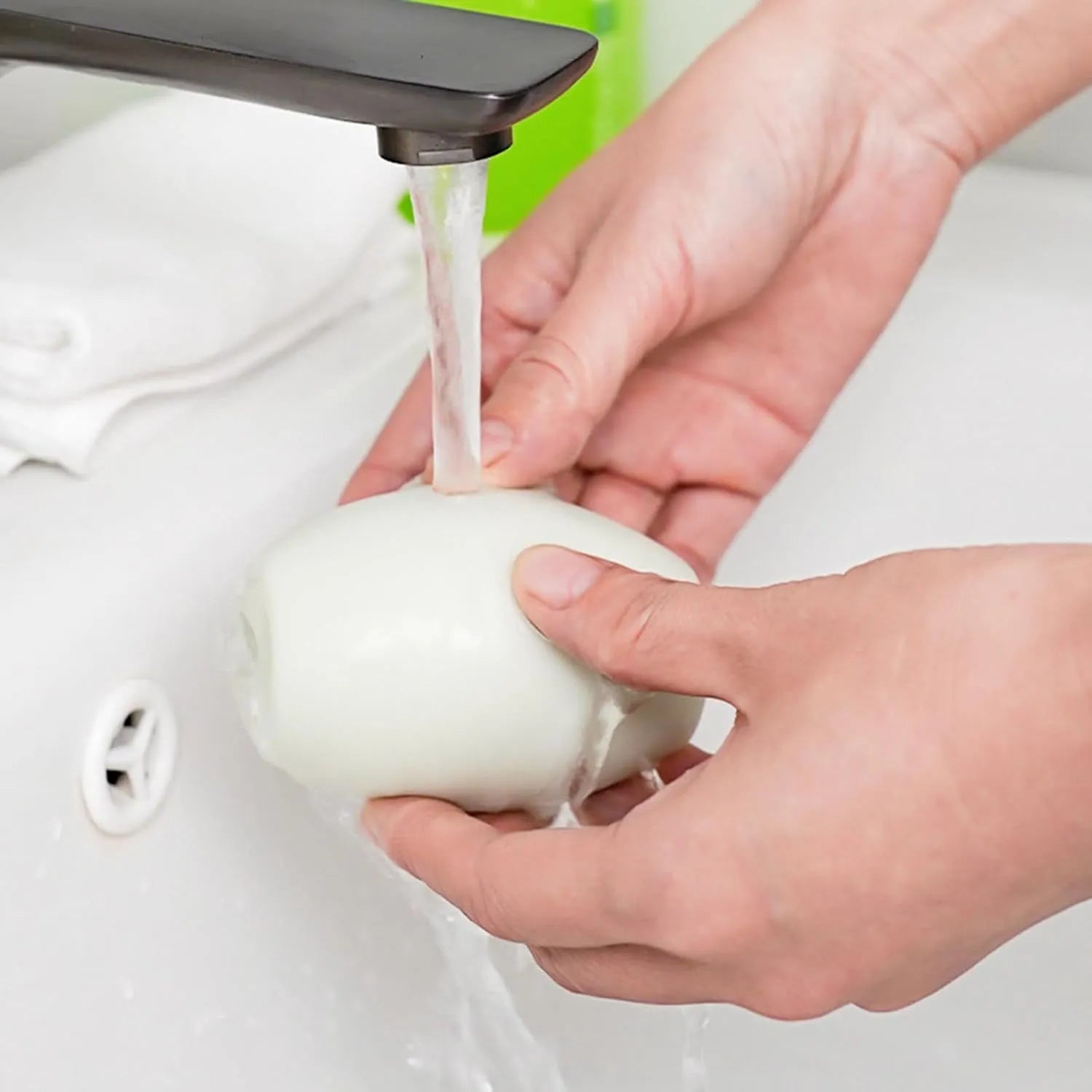 Green reusable gel lint roller ball for pet hair removal from fabrics