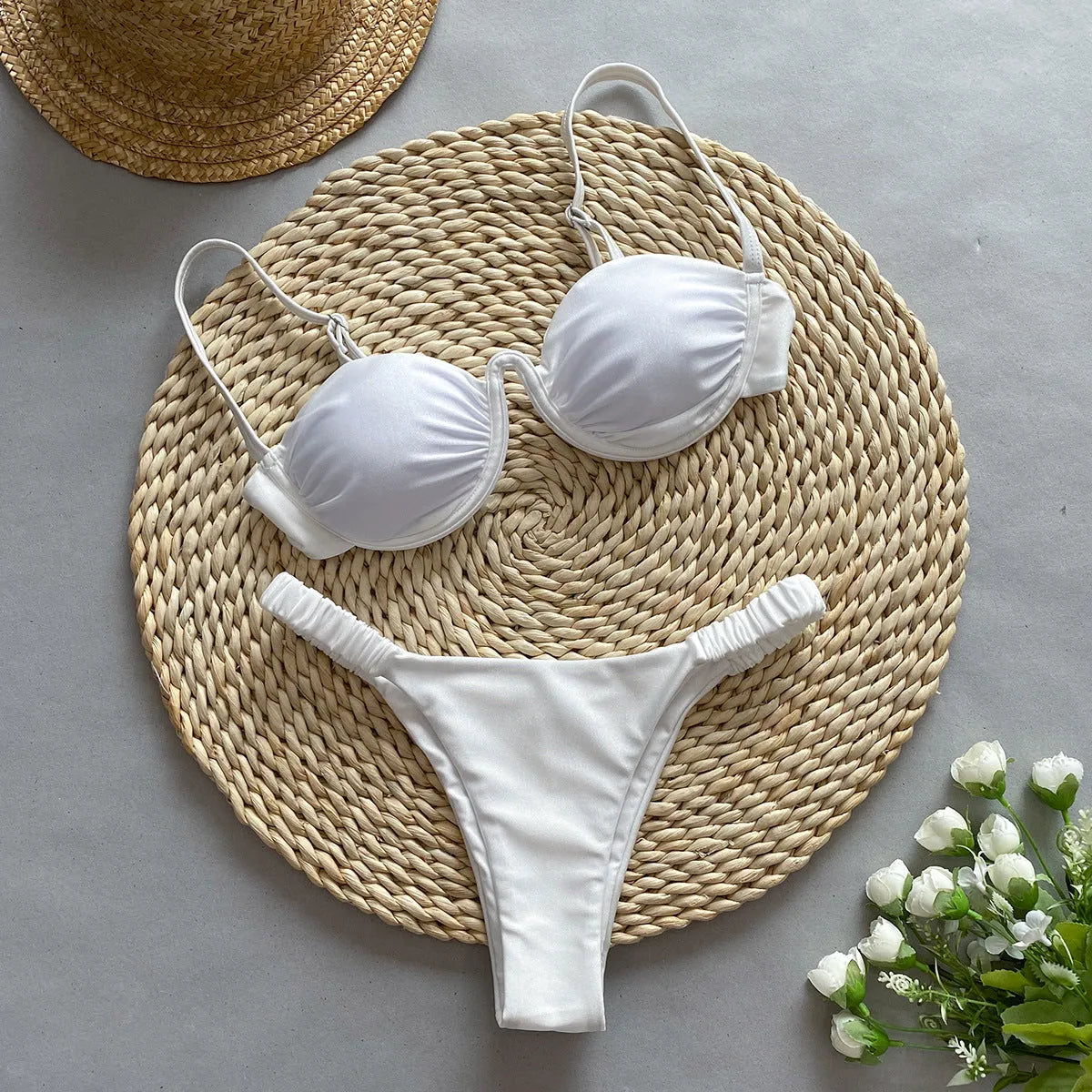 Women's black underwire bikini swimsuit set on a hanger.