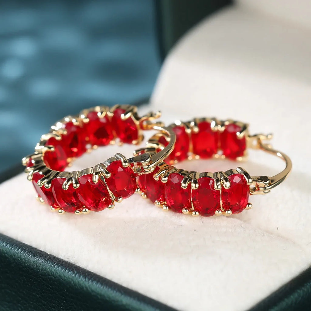 Egg-shaped ear clip earrings for women in electroplated copper, shown in platinum emerald, platinum sapphire blue and gold red