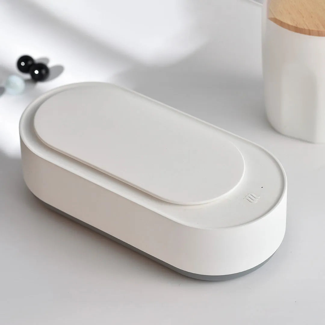 White portable ultrasonic cleaning machine with display and stainless steel tank.