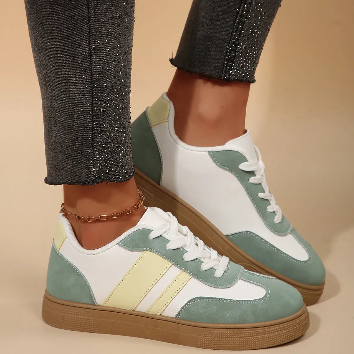 Green retro women's low-top pumps with cross straps, round toe, and flat rubber sole on a white background.