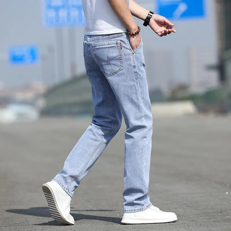 Man wearing smoky gray low-waist straight-leg jeans made from high-elasticity rabbit fur fabric.