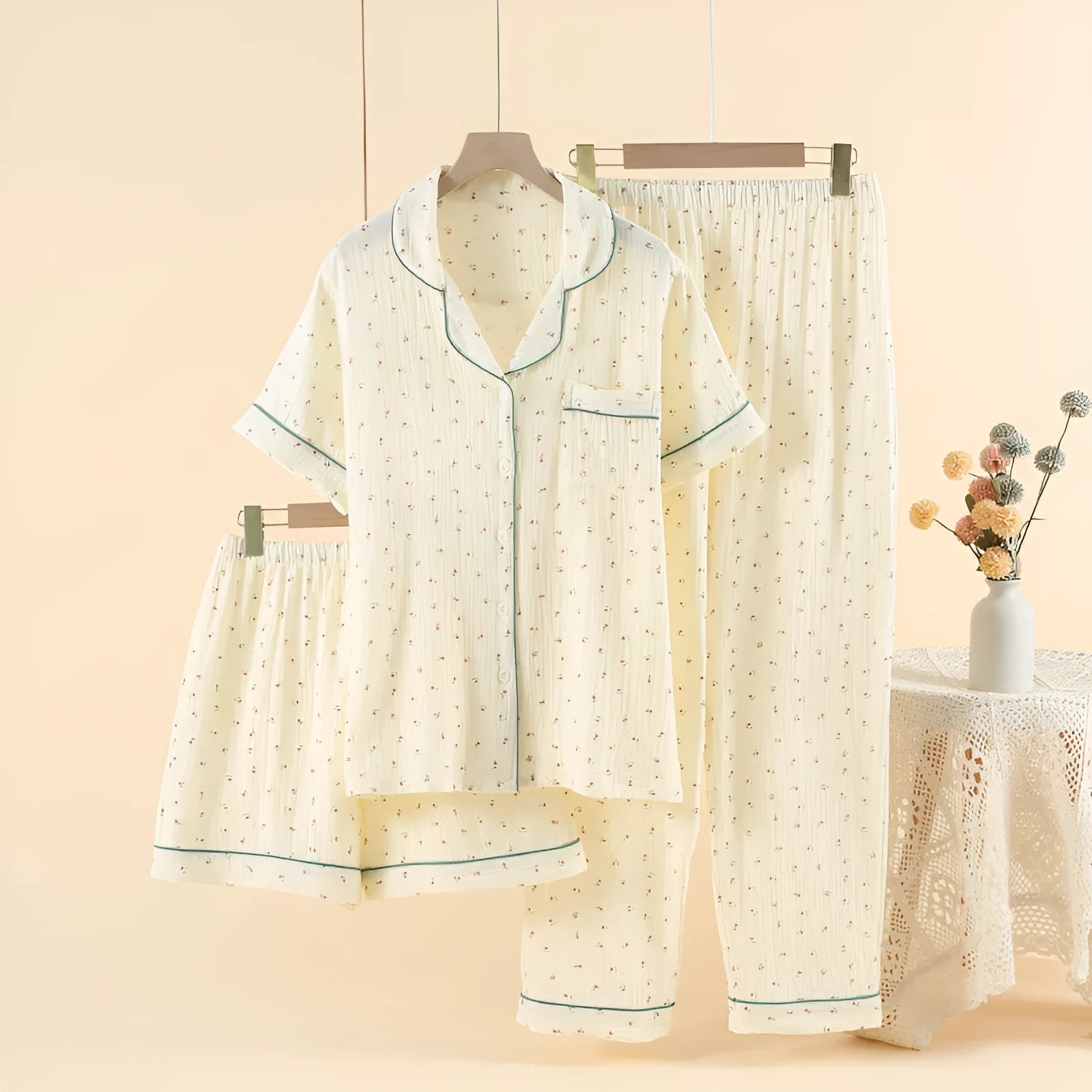 Women's garden gold cotton three-piece pyjama set with lapel collar and three-quarter sleeves laid flat.