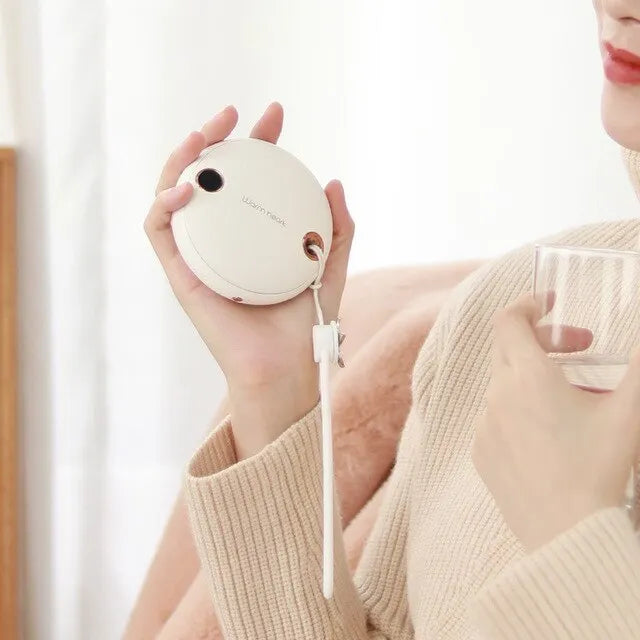 Green 5000mAh hand warmer power bank with digital display, shown next to its included USB charging cable.