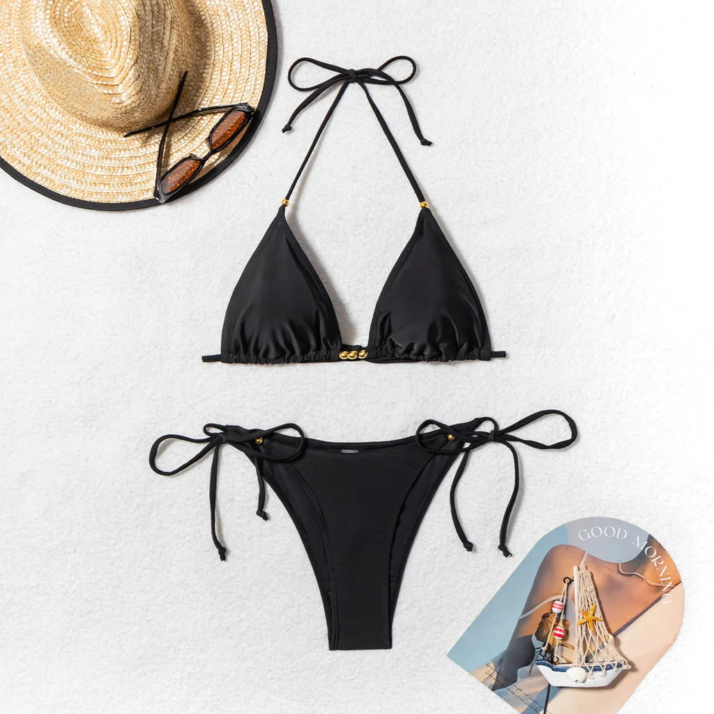 Black women's bikini swimsuit with metal bead detailing and split design