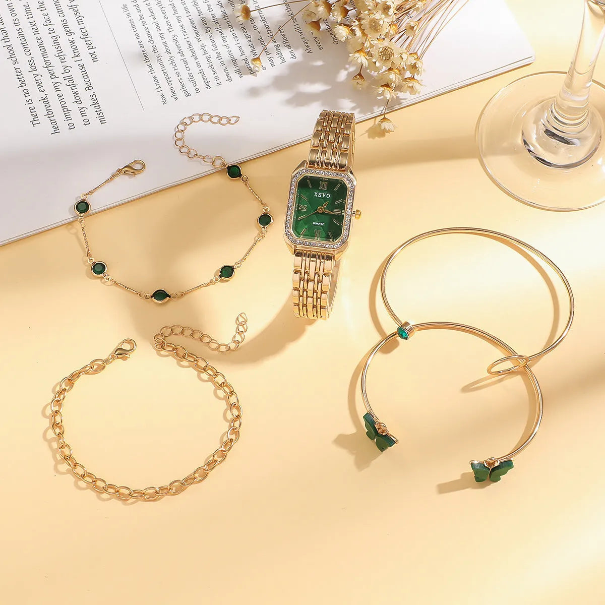 Gold green square women's watch with four matching butterfly bracelets on white background