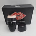 Black and white electric silicone lip plumper device with USB charging cable.