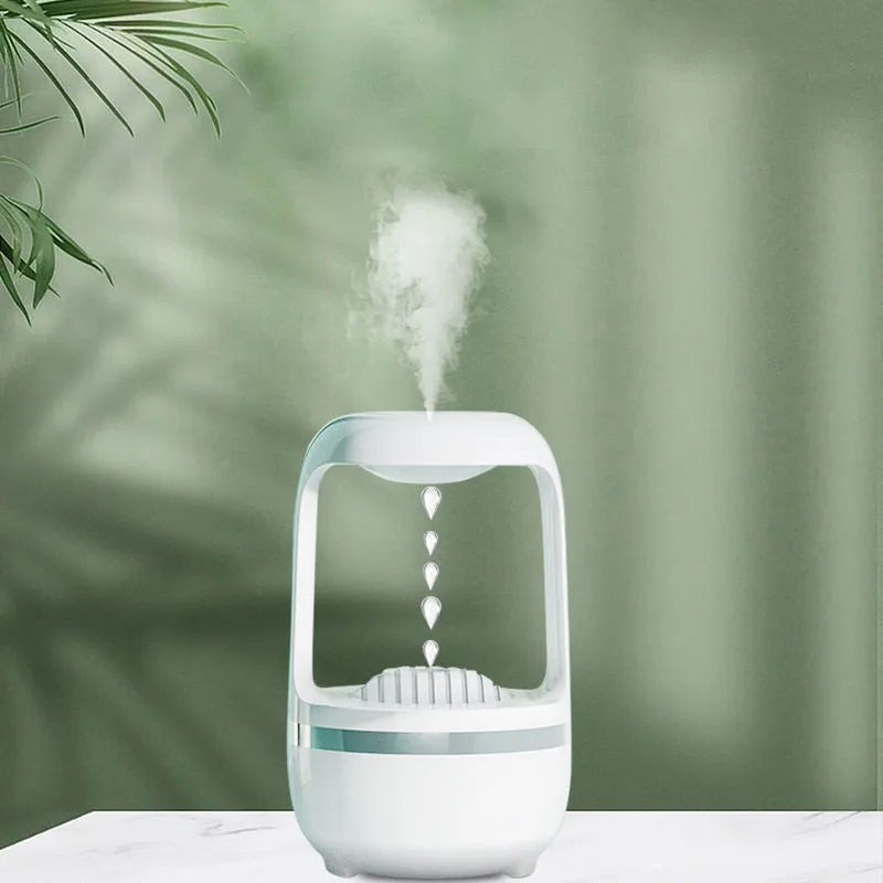 White anti-gravity humidifier showing water drop backflow effect with USB cable connection