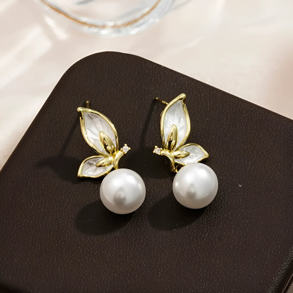 Close-up of a pair of zircon painting oil finish butterfly stud earrings on a copper base, style PT0203.