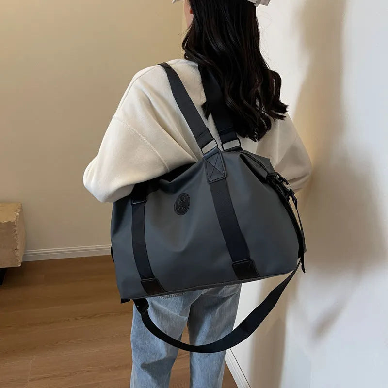 Large black waterproof Oxford cloth travel backpack with multiple compartments shown on a grey background.