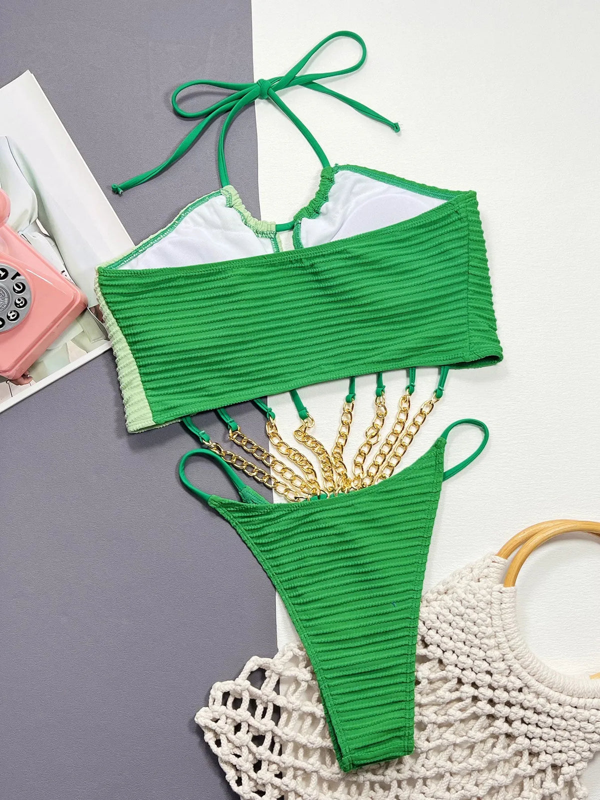 Green women's one-piece swimsuit with hollow back detail on mannequin