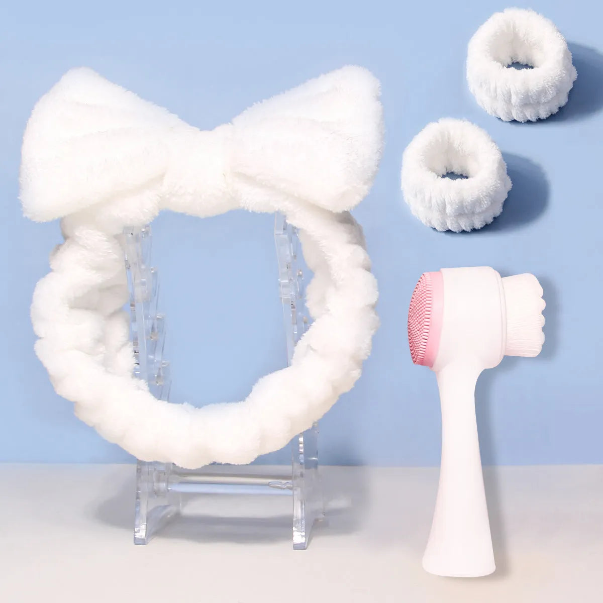 Facial brush set with coral fleece hair band, nylon brush heads, and plastic handle in purple, gray, white, or pink colours