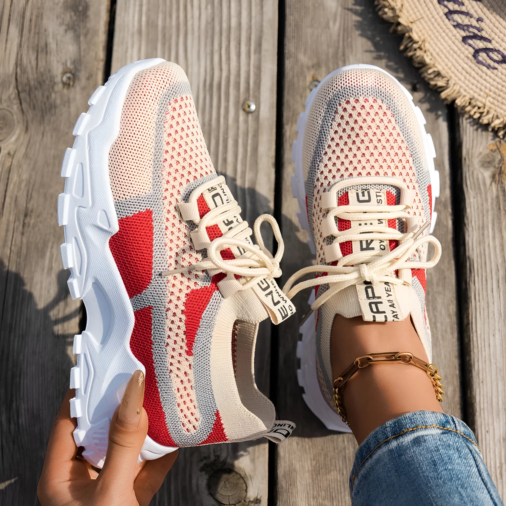 Women's Flyknit mesh lace-up sneakers in a colour option, showing the round toe and rubber sole.