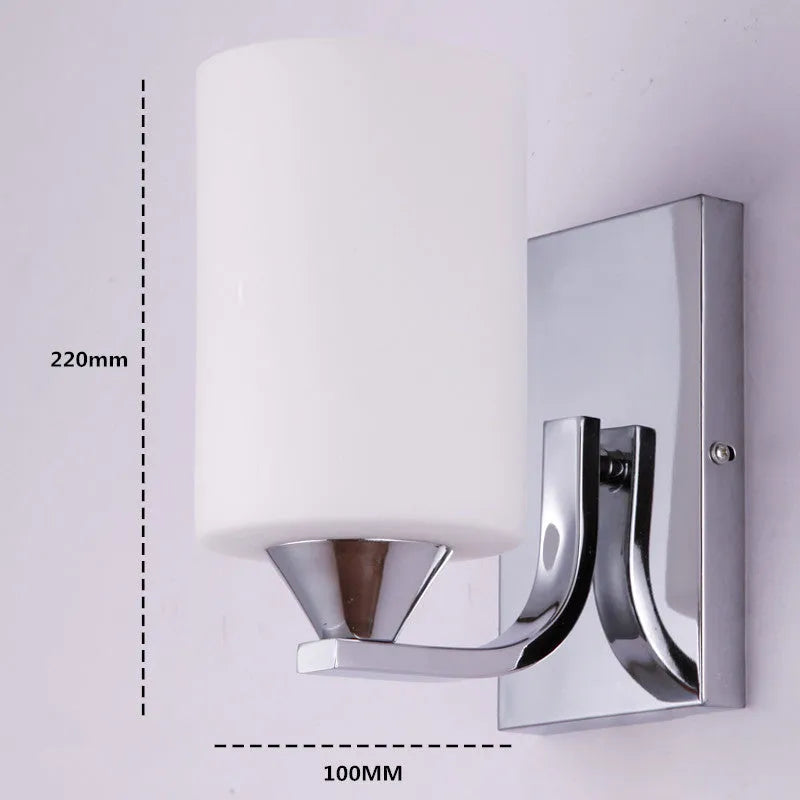 Chrome-finished wall lamp with glass shade in single head and double head configurations.