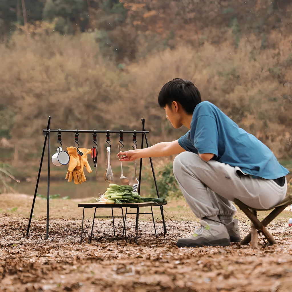 Large foldable aluminium alloy triangle frame camping drying rack with multiple hooks, shown with optional side hanger and top tray.