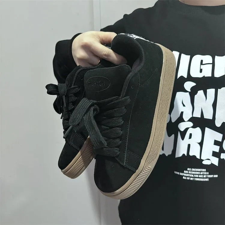Black retro sneakers with round toe, lace-up front, and waterproof platform on rubber sole