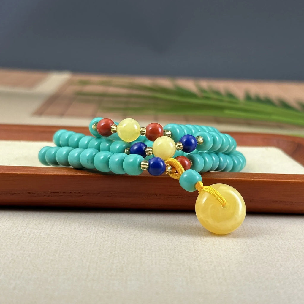Hand-woven turquoise mesh flower lucky pendant necklace on a ball bead chain.
