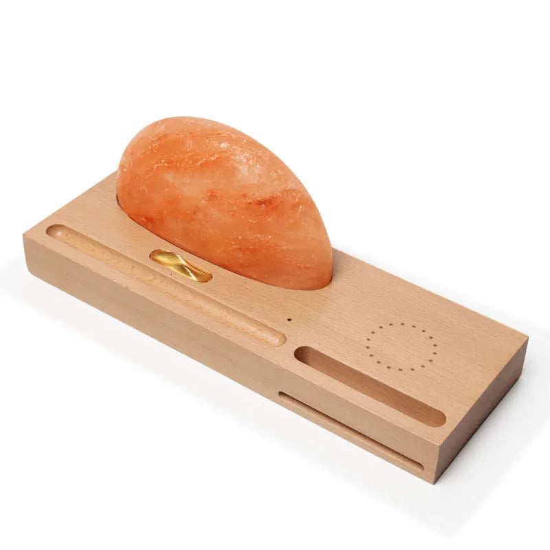 Natural crystal salt lamp with beech wood base featuring integrated wireless phone charging.