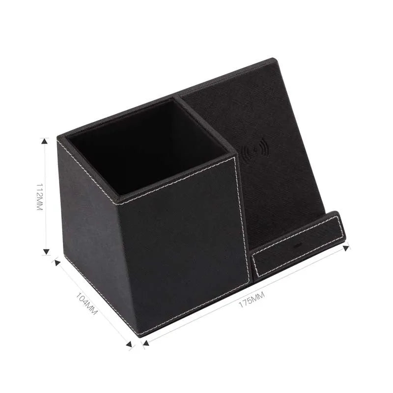 Black leather wireless charging station with pen holder slots showing phone charging on surface