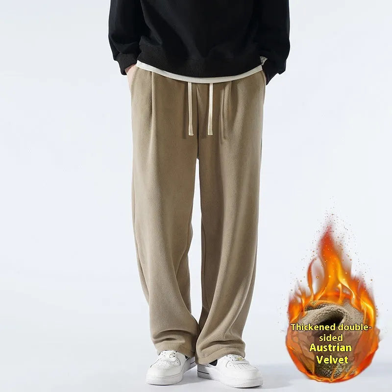 Men's loose fit apricot coloured fleece-lined sports pants with a drawstring waist on a hanger