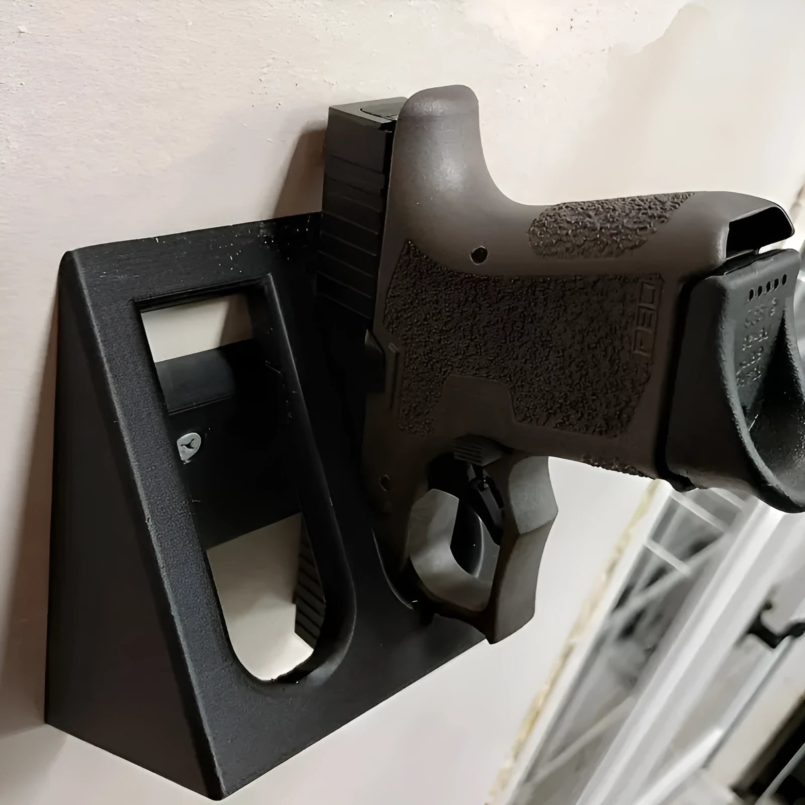 Black plastic punk-style pistol display stand for collectible models.