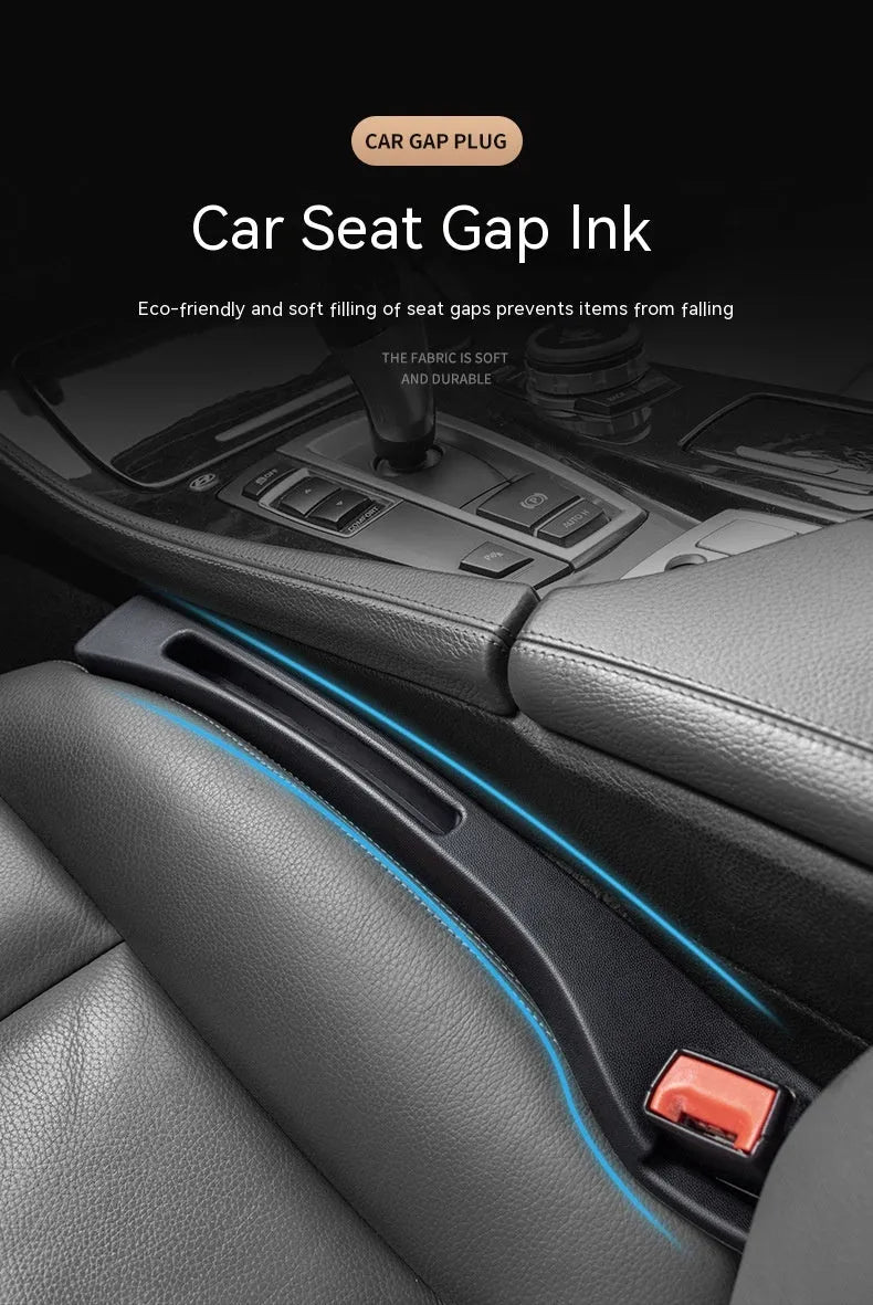 Black plastic car seat gap storage organiser box with a handle, shown inserted between vehicle seats.