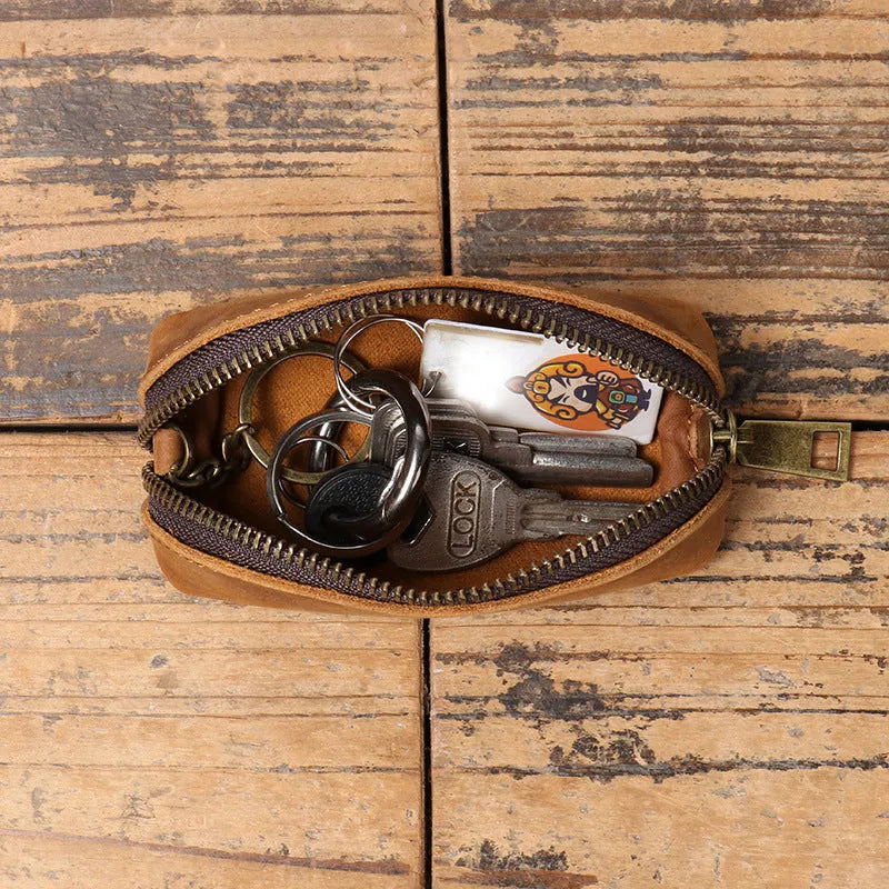 Men's leather clutch coin purse in first layer cowhide with chain, shown in brown yellow, dark brown or black