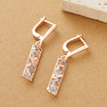 A pair of rectangular hollow stud earrings with a two-tone electroplated finish on a white background.