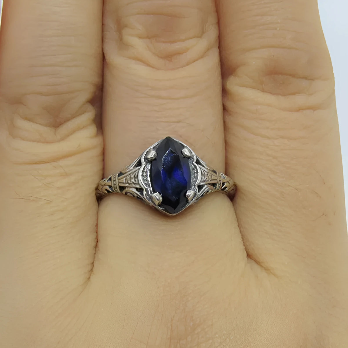 Silver women's ring with geometric hollow pattern in alloy metal showing side profile view