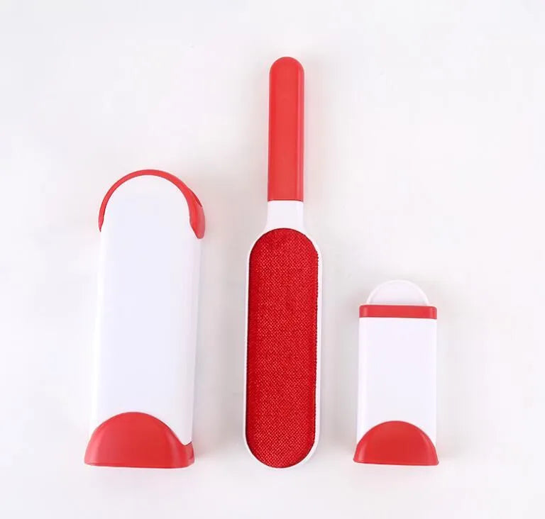 Blue reusable pet hair removal brush with self-cleaning base on a grey sofa.