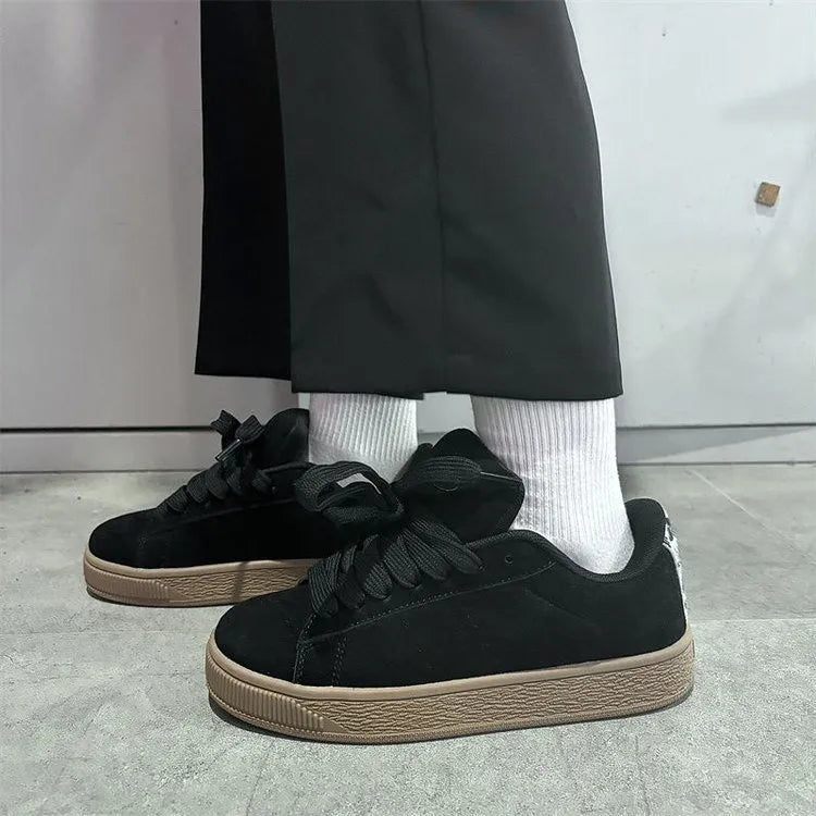 Black retro sneakers with round toe, lace-up front, and waterproof platform on rubber sole