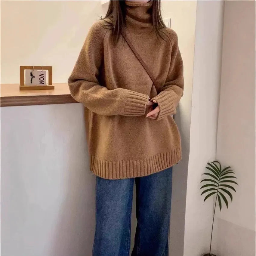 Red women's loose fit turtleneck sweater with a thick knit and curly pile collar on a hanger.