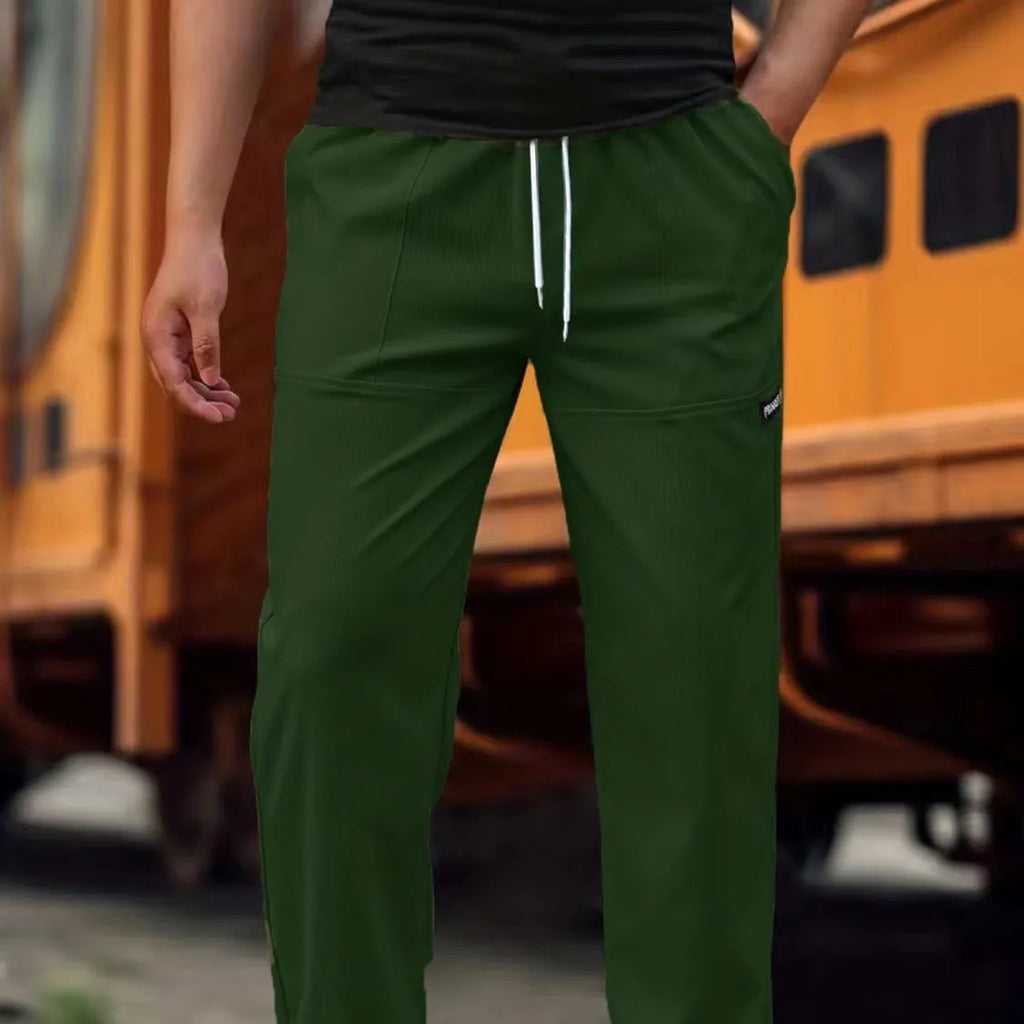 Men's light grey polyester trousers for spring and autumn seasons laid flat.